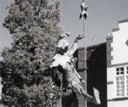 A statue of a jester or fool.